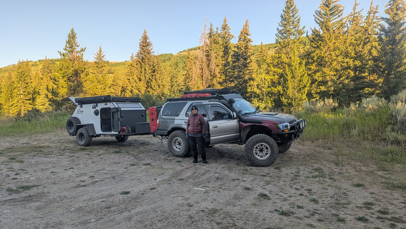 A person stands with a modified Toyota 4Runner towing an XTR off-road RV rental trailer. Ready for rugged overlanding & camping. — photo 17
