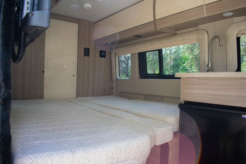  & green window view.|RV rental interior featuring a versatile bed — photo 12