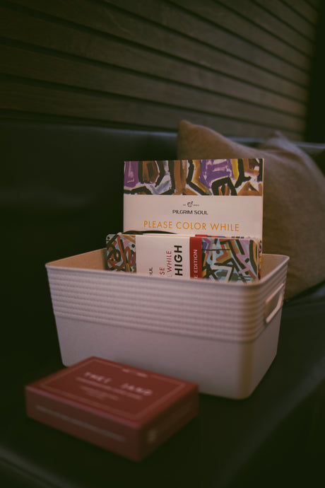 Relaxing during your rv rental trip! A basket holds "Pilgrim Soul Please Color While High" coloring books and a card deck.