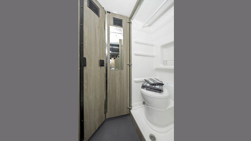  and shelf. Towels are neatly folded on the toilet.|Inside an RV rental van: dashboard — photo 7