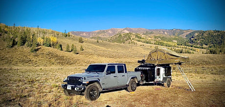 Experience off-grid adventure! This Jeep Gladiator & overlanding trailer with rooftop tent offer the perfect RV rental for mountain camping.