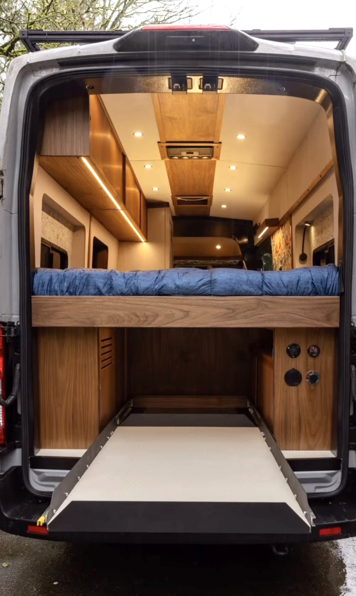  overlooking a forest view. Ideal for pet-friendly van travel.|Explore this custom RV rental's cozy interior — photo 3