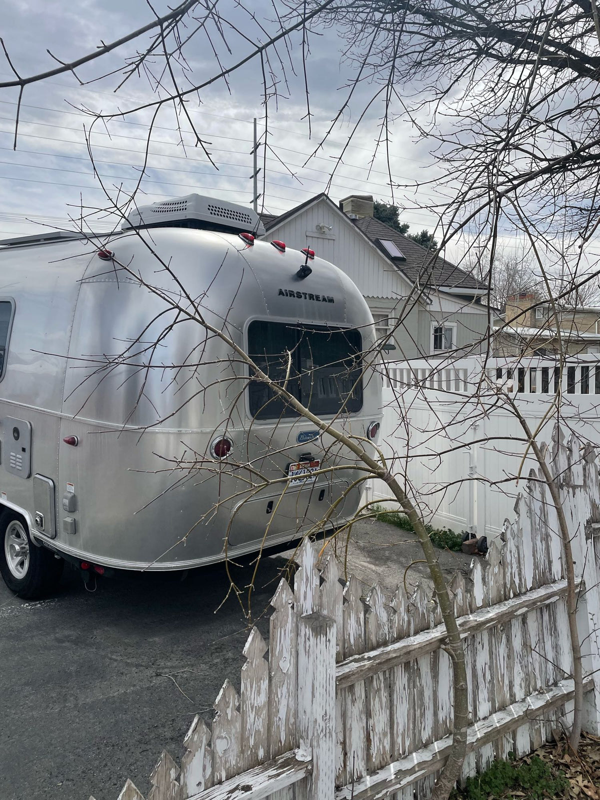  perfect for any weather. Rain visible outside.|This RV rental kitchenette shows a compact cooking area with a sink — photo 10