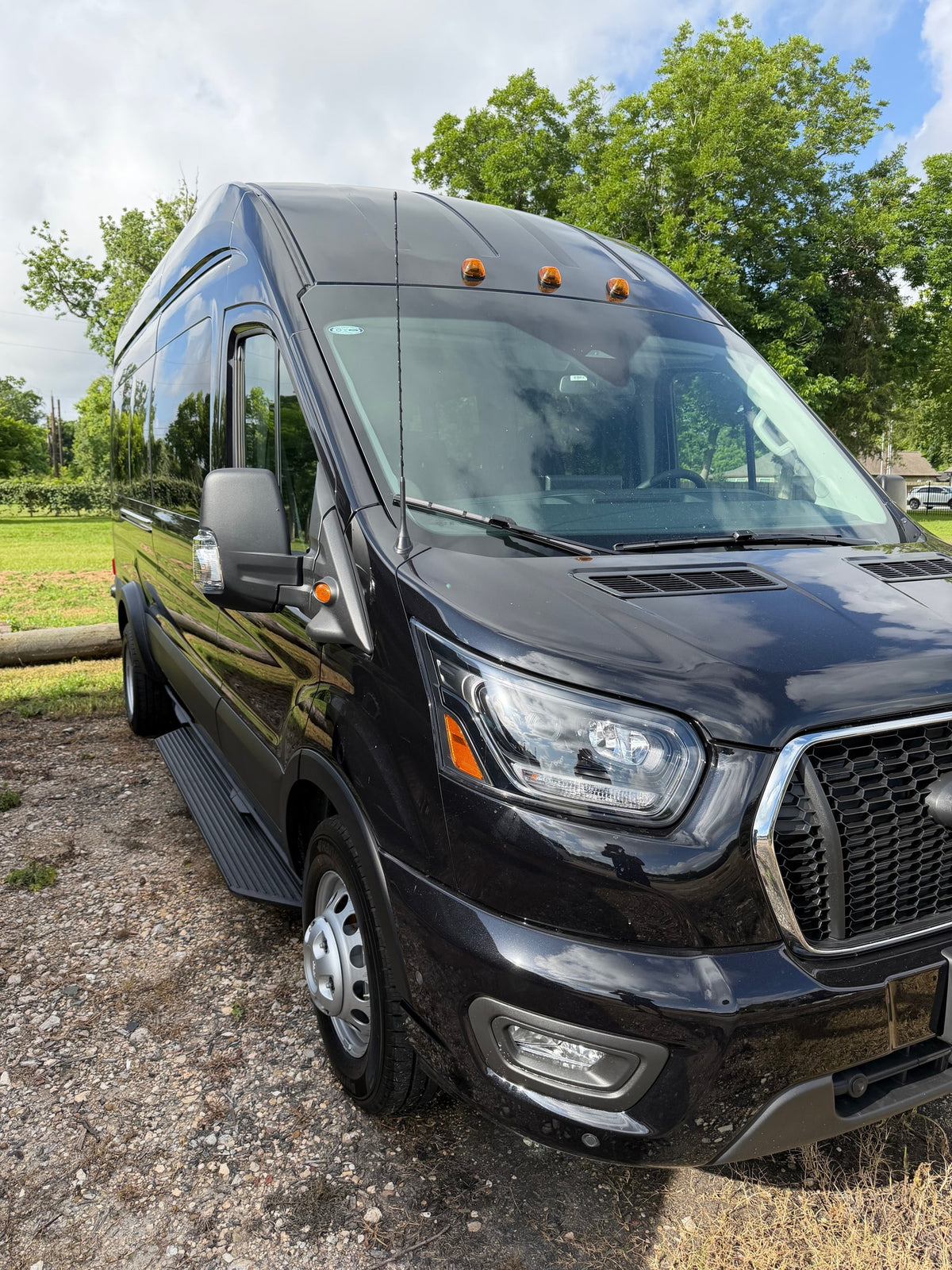  reflecting sky & trees on its sleek surface.|Rear interior of a roomy passenger van — photo 10