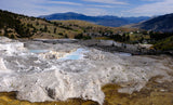 Mammoth Hot Springs, Yellowstone: White travertine terraces, blue geothermal pools, & a boardwalk. Explore this unique site via rv rental.