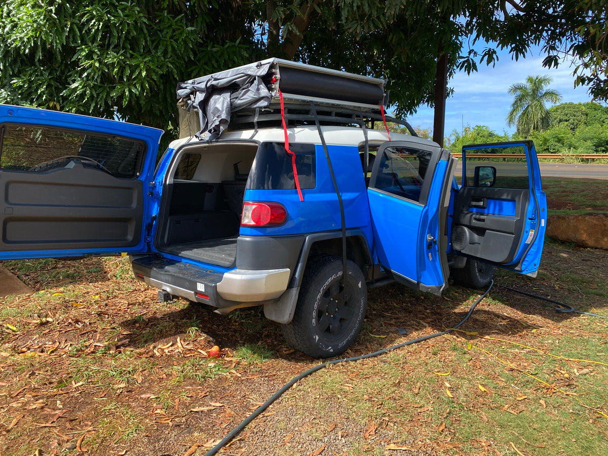 Blue FJ Cruiser with rooftop tent & open doors. An off-road RV rental alternative for camping adventures. — photo 3