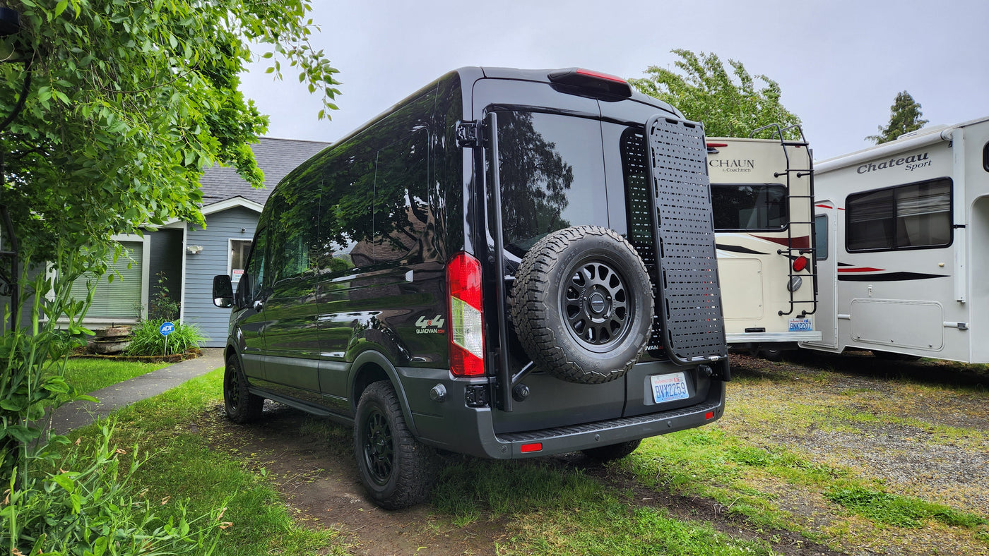 A black Mercedes Sprinter 4x4 van, equipped for adventure (possibly an RV rental), parked near other RVs. — photo 2