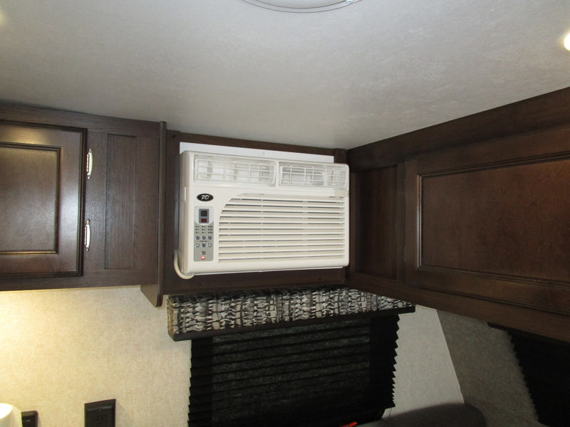  is shown parked from its side and rear view.|RV rental: a functional kitchen with stove — photo 6