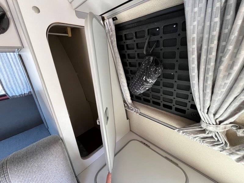  perfect for an RV rental. Features kitchen & seating area.|A person's hand holds open a compact fridge in an RV rental — photo 8