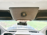 Inside an RV rental: a Webasto heater control panel, dashcam, and overhead light on a custom console.