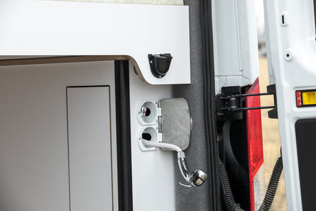 RV rental's rear utility panel features an outdoor shower and water hookups for convenient use.