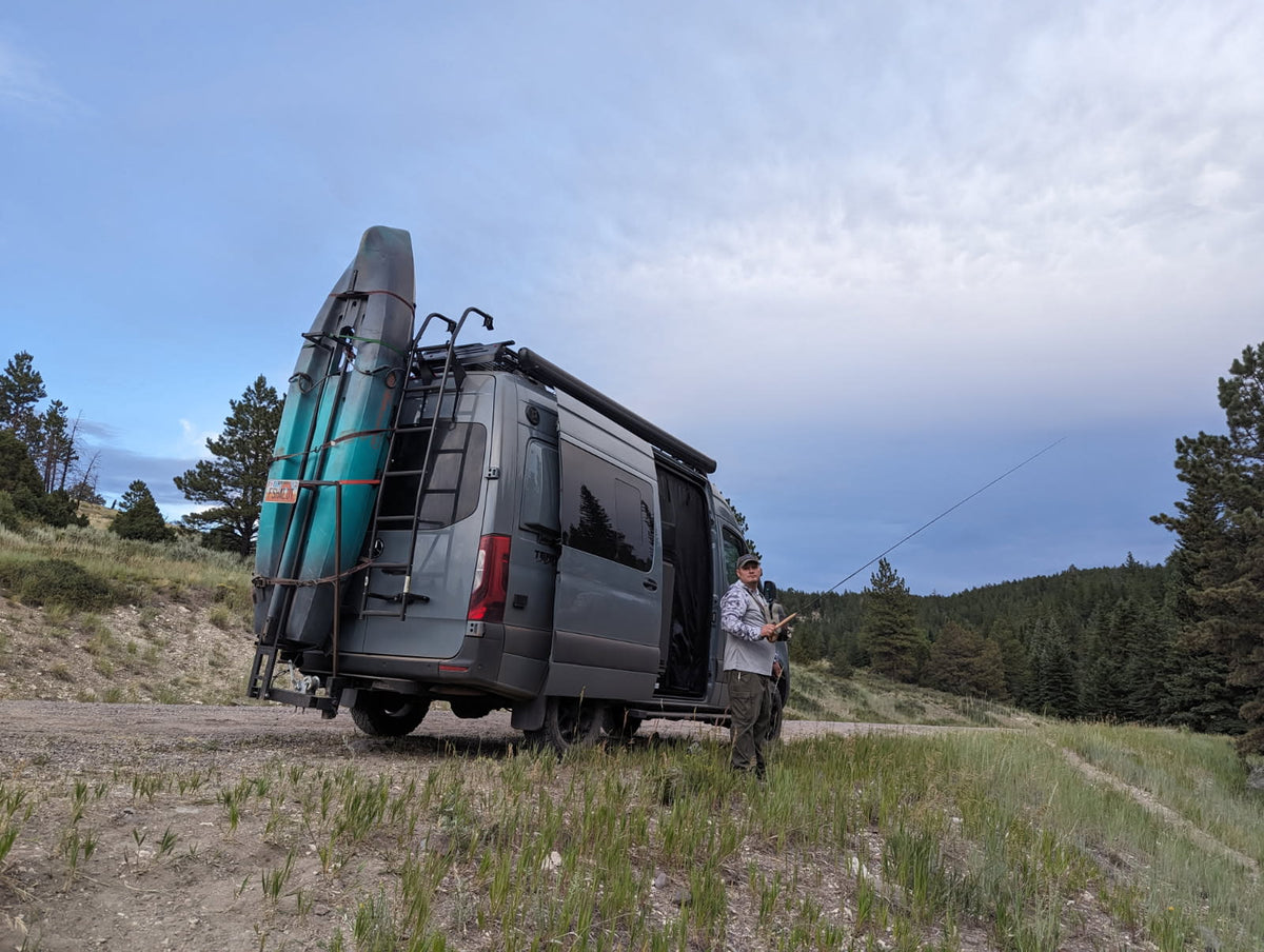 An RV rental (van type) with kayaks on back