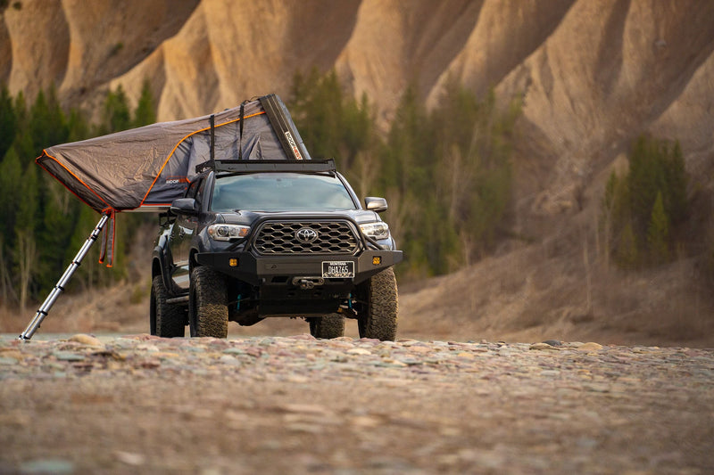  hills behind. Ideal for a rugged rv rental camping trip.|Cozy interior of a Roofnest rooftop tent — photo 2