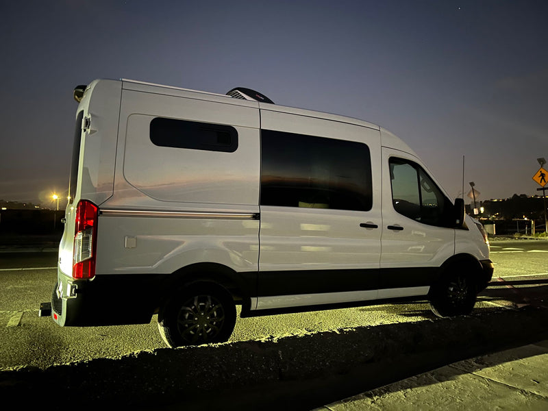  parked amidst dark mountains. Perfect for night adventures!|This white Ford Transit camper van is an ideal RV rental — photo 14