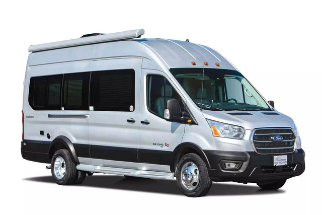 A bright silver Coachmen Beyond camper van, a Class B RV on a Ford Transit chassis, perfect for RV rental trips.