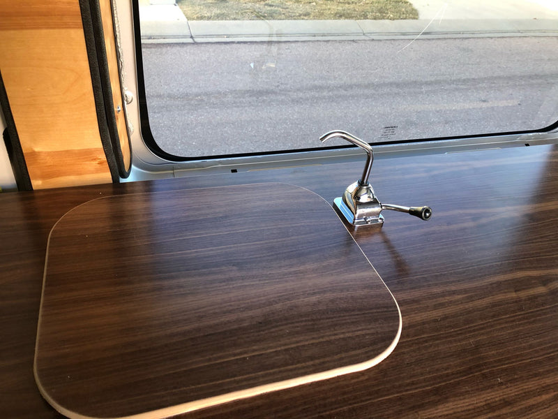  and a pull-out wooden table.|A silver Ram ProMaster camper van — photo 11