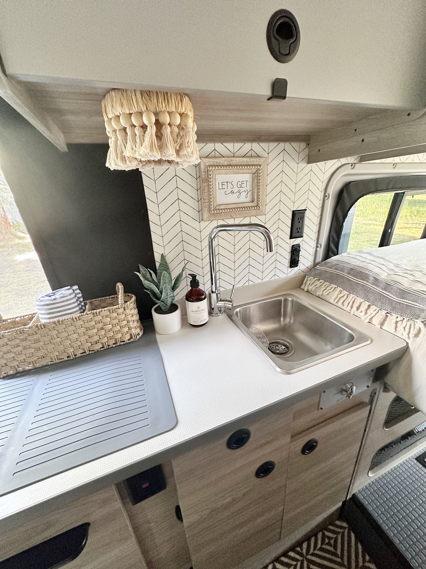  and a plush rear lounge.|RV rental kitchenware: blue and floral bowls — photo 14