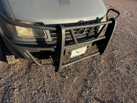 Textured gray Mercedes-Benz Sprinter rv rental with a heavy-duty brush guard, Arizona license plate, and off-road tires.