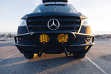Front view of a custom black Mercedes-Benz Sprinter adventure van, featuring yellow off-road lights and a rugged bumper. Ideal for an RV rental.
