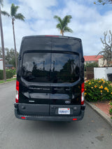 Rear view of a black Ford Transit 350HD XLT van, popular for rv rental conversions, parked on a California street.