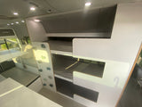 Inside a modern **rv rental**: bunk beds with a fun climbing wall, plus a comfortable dining/seating area.