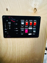 RV rental control panel: displays tank levels, battery status, and controls for interior/exterior lights, heaters, water pump, and furnace.