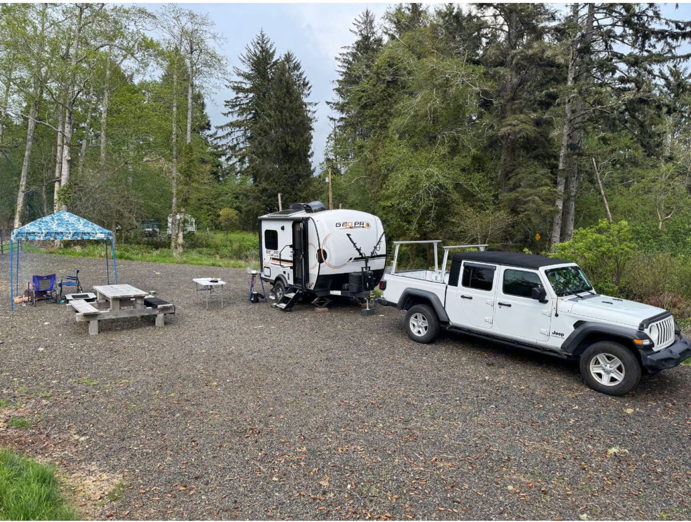  dry grassy field under clear skies.|Cozy RV rental camping setup with a dog — photo 3