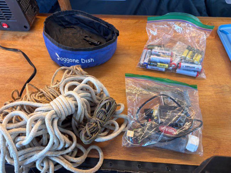 "Joggone Dish" pet bowl, assorted ropes, batteries, and electronic gear packed for an RV rental trip. — photo 19