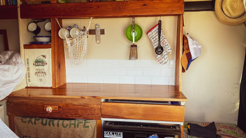  and stunning ocean views protected by a mosquito net.|Comfy camper van RV rental interior: raised bed — photo 9
