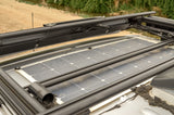 Rooftop solar panels on an RV rental, showcasing sustainable power for remote travel and outdoor living.