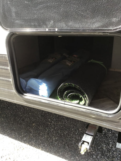 and window blinds. An inviting space for meals in a camper.|Compact RV rental kitchen featuring a modern stove with blue lights