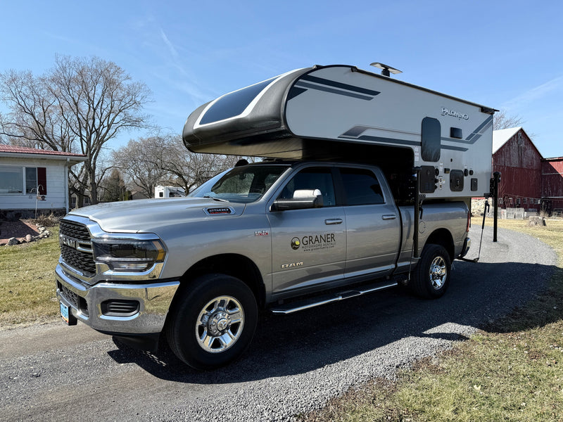 A silver RAM pickup with a Palomino truck camper, from Graner RV rental, ready for outdoor adventures. — photo 8