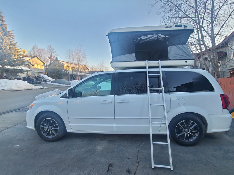 White minivan RV rental with an open pop-up rooftop tent & ladder. Perfect for camping. — photo 1