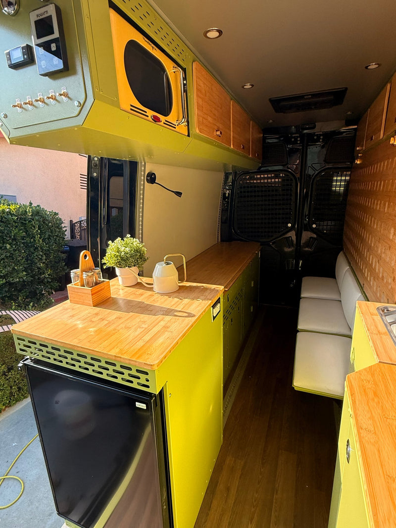 and wooden cabinets for adventure.|Vibrant lime green and wood RV rental interior featuring a kitchen — photo 9