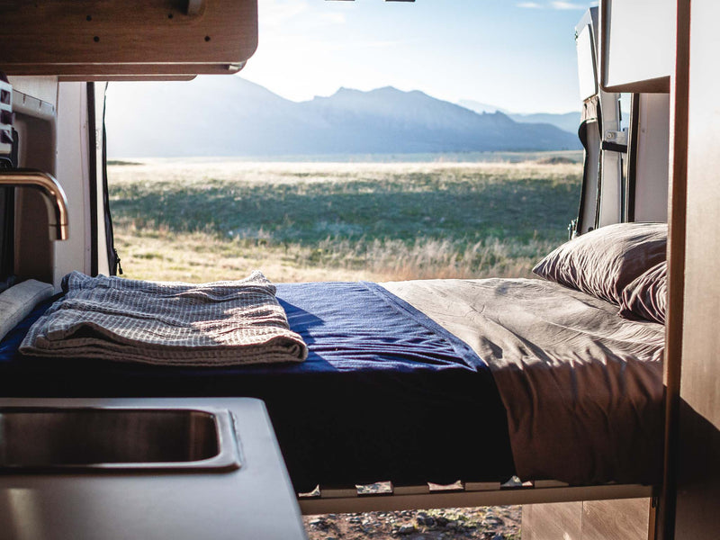  offering scenic views of large rocks from the camper van.|Compact rv rental interior featuring a kitchen with sink — photo 18