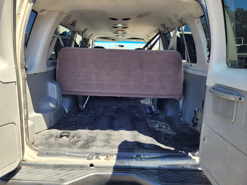 Rear interior of an RV rental van, showing the back bench seat and versatile floor for cargo/seating. — photo 7