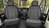 RV rental interior: Front cabin shows two grey fabric seats, a modern dashboard, and a beautiful forest road view.