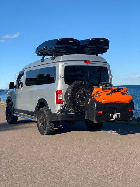  ideal for adventure.|Silver pop-top camper van with front cargo rack and overland setup