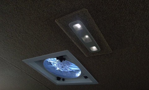 RV rental interior: Bright LED lights and a functional fan vent on the ceiling, enhancing comfort during travel. — photo 6