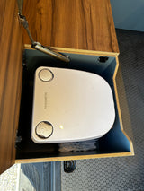 A Dometic portable toilet sits in a sleek, built-in cabinet in an RV rental, offering a practical solution for camper van trips.