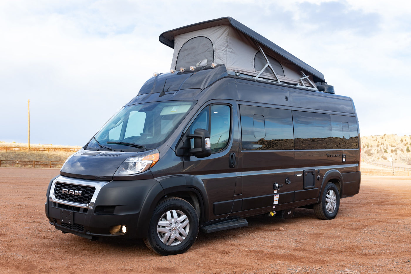  parked on red dirt. Ideal for your next RV rental adventure.|Dark grey Tellaroo camper van — photo 14