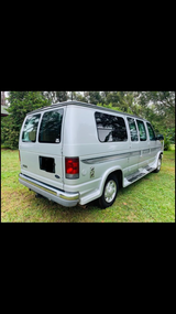 This silver Ford Econoline conversion van is perfect for an RV rental. Ready for your next travel adventure!