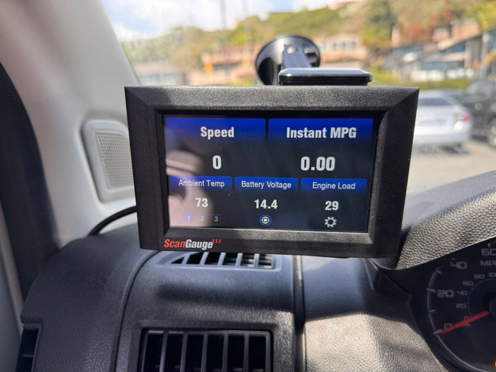 ScanGauge in an rv rental displays vehicle data: speed 0, ambient 73°F, battery 14.4V, and engine load 29.