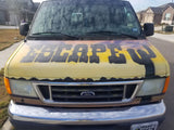 A distinctive yellow Ford van with "ESCAPE" and cactus art, ideal for your next RV rental road trip.