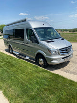 A sleek silver Mercedes Sprinter Winnebago camper van, perfect for your next RV rental journey, parked on a sunny day.
