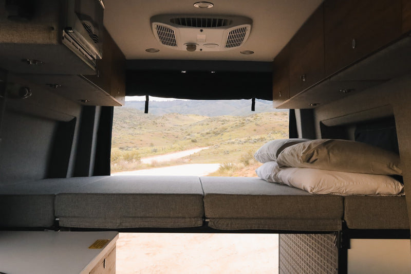  and integrated controls for travel.|RV rental interior: convertible black leather seating with seatbelts — photo 6