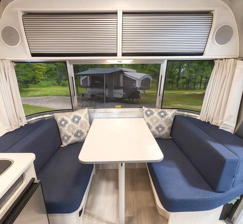  perfect for travel trailer adventures.|Cozy RV rental bedroom featuring a comfortable bed and a window view of another camper outside.|Experience comfort in this RV rental's compact bathroom. Includes a toilet — photo 6