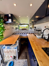 Explore this stylish RV rental! Features a comfy bed, compact kitchen, and smart storage for your next road trip.