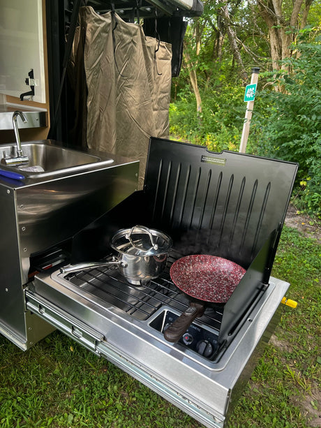 Enjoy nature's kitchen! This RV rental features a pull-out stainless steel sink & Dometic stove for outdoor cooking.