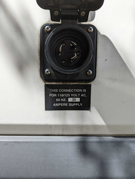 RV rental 30-amp, 110/125V AC shore power inlet. Essential for RV electrical connection, charging, and appliances.